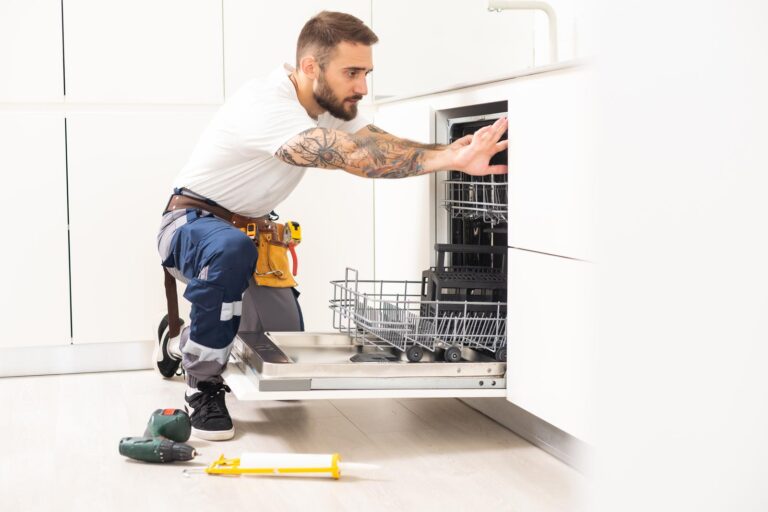 plumber working on dishwasher