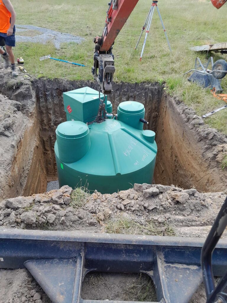plastic septic tank being installed in the ground in Hamilton
