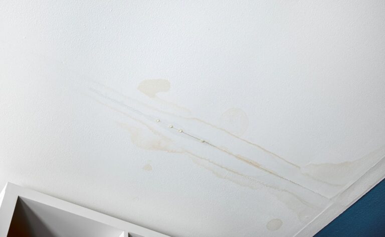 Water dripping from a crack in the ceiling of a home.